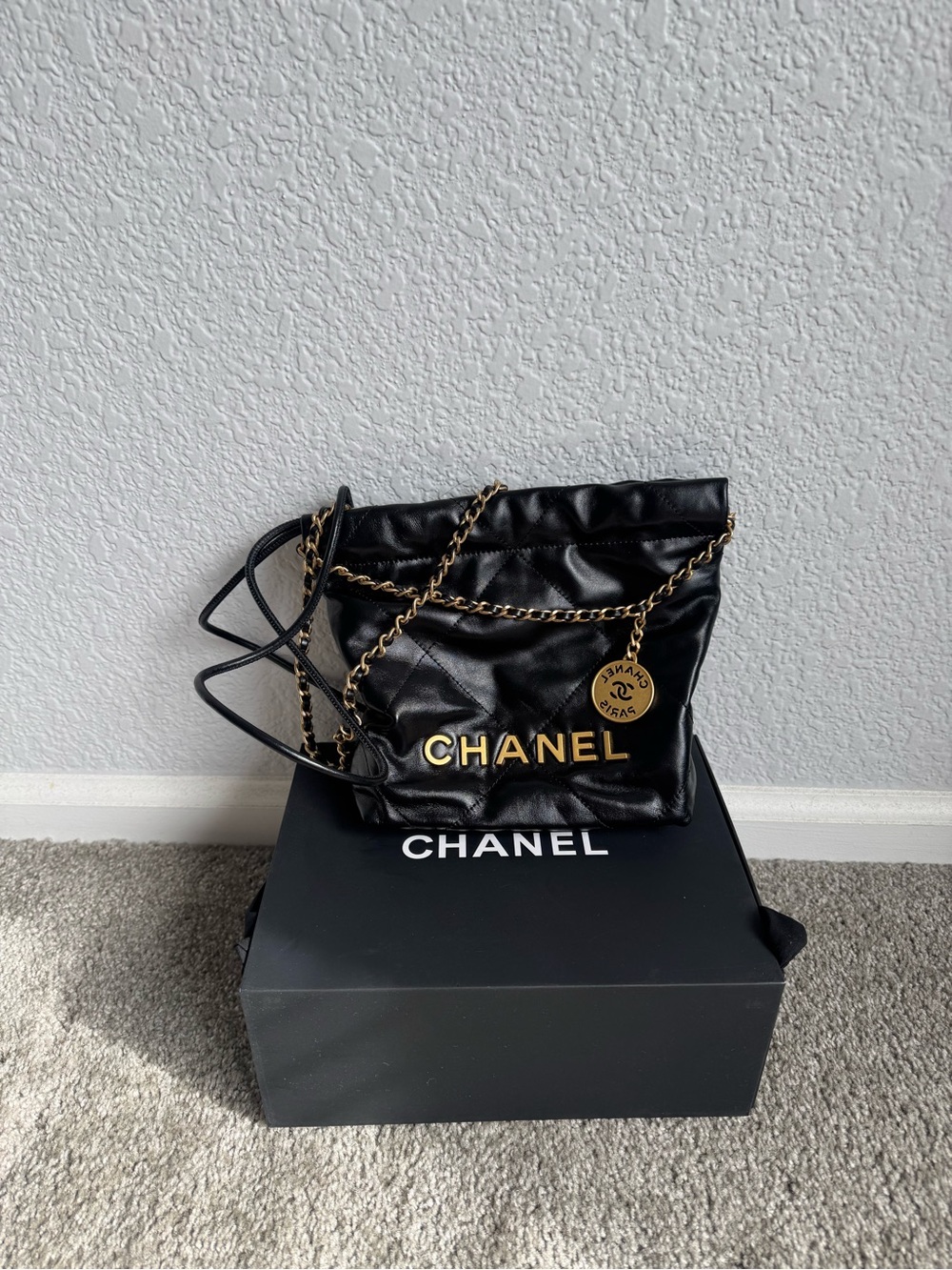 CHANEL Black Leather Mini Bag with Gold Chain & Logo Medallion